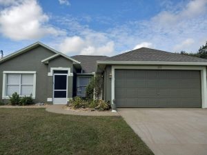 After photo of a deep sage green home when Joe Caslin and crew painted it