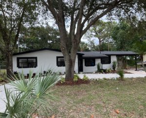 A black and white house painted by Joe Caslin and crew in Titusville FL off HWY 50